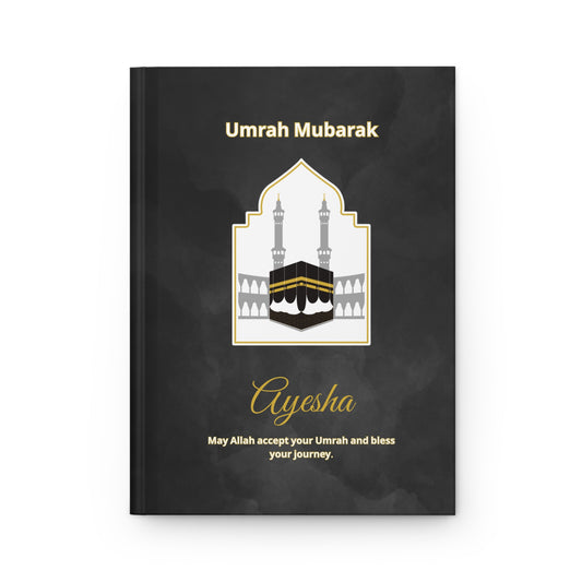 Personalized Umrah notebook with Kaaba illustration, dua in Arabic and English, and name Ayesha on matte black hardcover