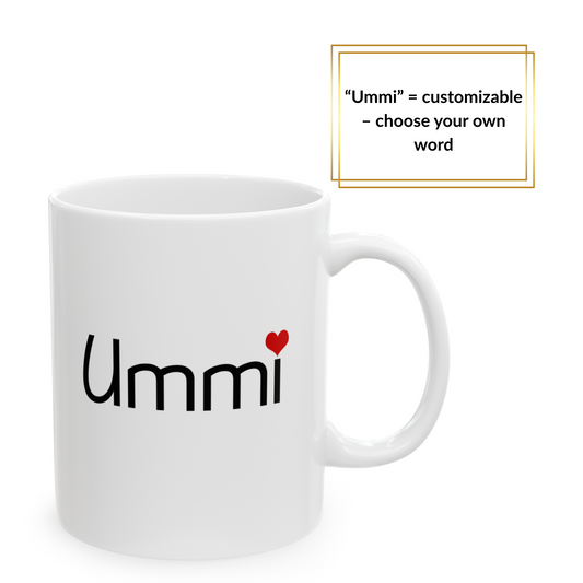 White ceramic mug with black “Ummi” text and red heart – styled on soft mint green blanket, Islamic gift for mom.