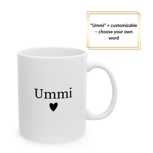 White mug with black “Ummi” and heart, held by woman in cozy cream sweater – elegant Islamic gift for mom.