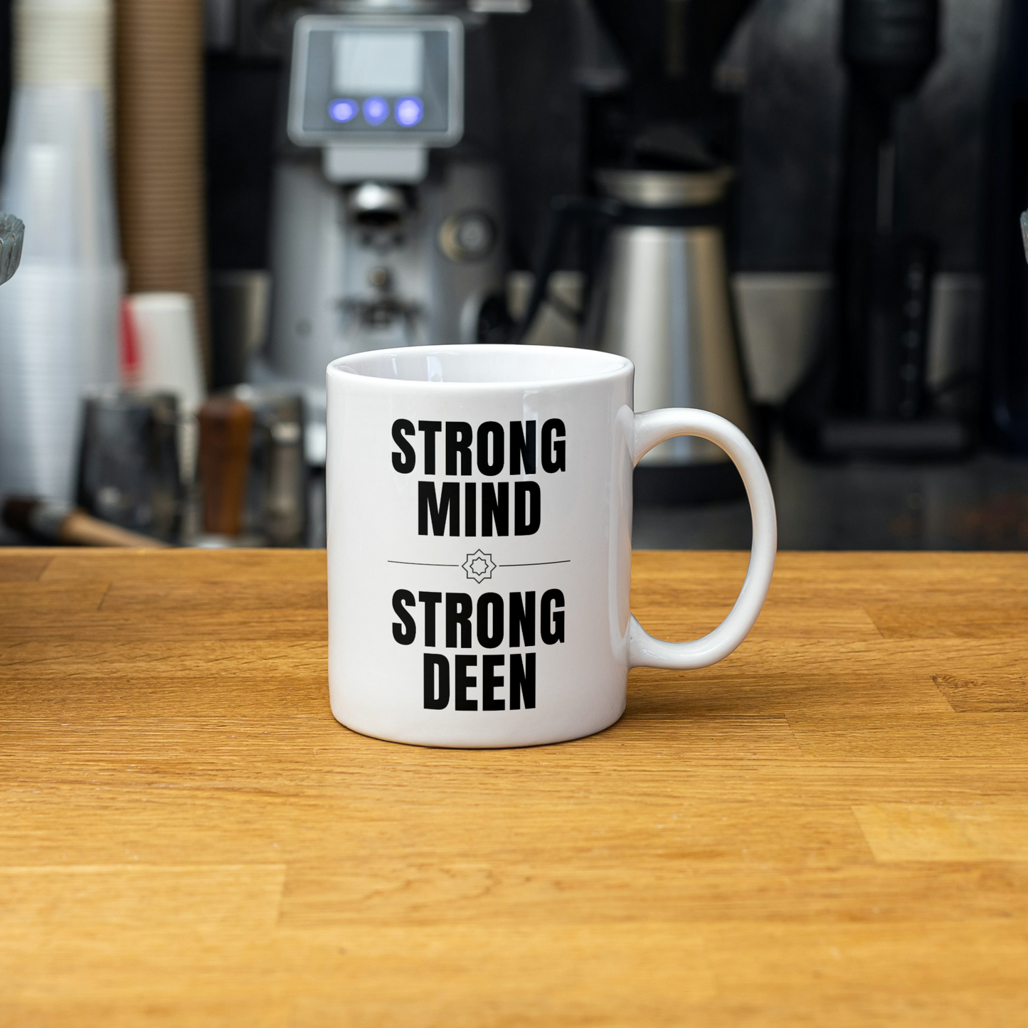 White mug on a cozy blanket with the bold Islamic quote “Strong Mind, Strong Deen” – perfect Muslim gift for him.