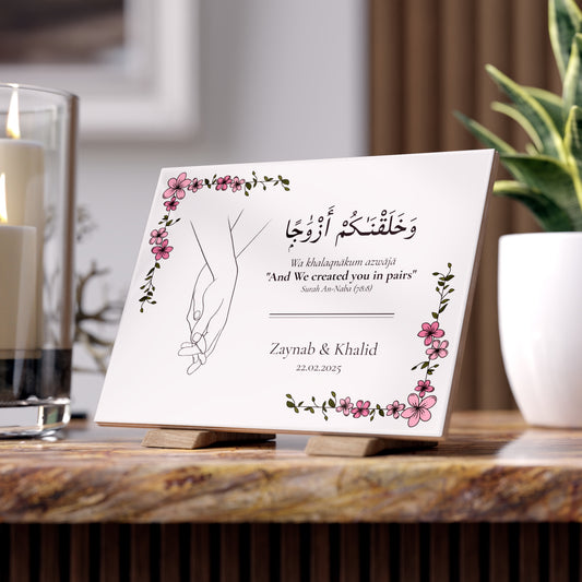 Personalized Islamic wedding tile with floral frame, hand-in-hand drawing, and Quran verse “We created you in pairs” in Arabic and English